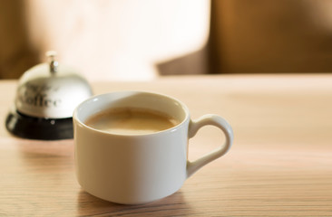 A cup of coffee. The concept of early awakening.  Steaming coffee cup on a background of sunbeams, coffee good time. Good morning coffee.Background with copy space for text