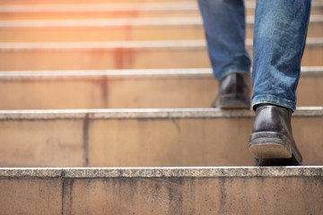 The image of a man walking up the stairs