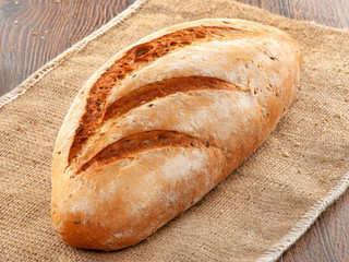Composition of bread close-up on a wooden background.