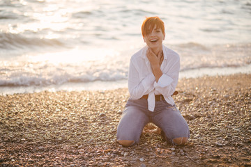 Woman with short haircut posing on beach