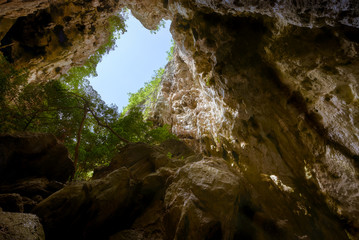 rock in cave with lighting from whole of outside