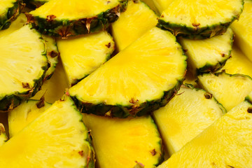 Pineapple juicy yellow slices background. Top view.