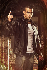 Action Hero. Handsome , Strong Looking Men Holding a Gun