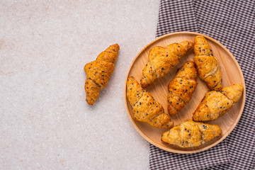 homemade whole wheat croissant bread on marble kitchen table, top view with copy space for text