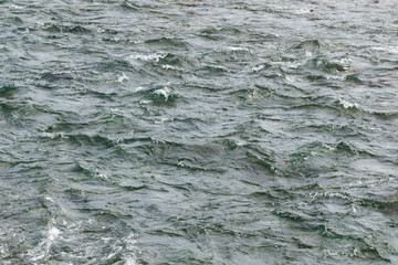 Surface of bubbling water in a mountain river background texture