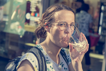 Female brunette tasting delicious bevarage at outdoor market place.
