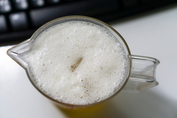 Bubbling beer in a glass with cool ice