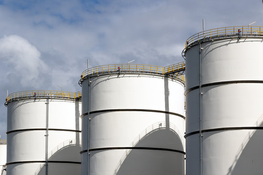 Row of oil storage tanks.