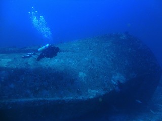 diver in the sea shipwreck 