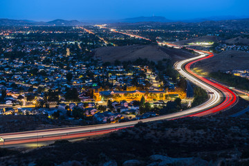 Fototapeta na wymiar Twilight view of commuter freeway traffic in suburban Simi Valley near Los Angeles in Ventura County, California.