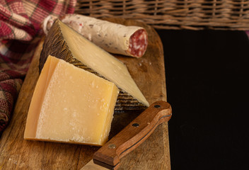 Cheese board and Iberian sausage on slate stone