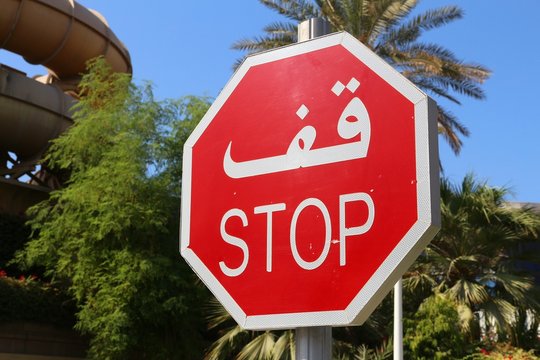 Stop sign in Dubai - with words written in Arabic and English.