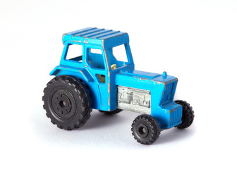 Blue toy tractor on white