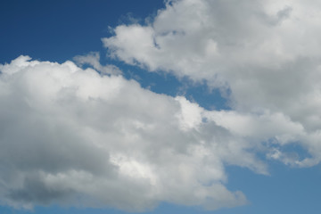 Fototapeta na wymiar Large cumulus clouds on a bright blue sky