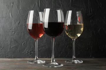 Fotobehang Glasses with different wine on wooden background, space for text © Atlas