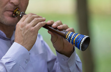 man playing on an asian horn - obrazy, fototapety, plakaty