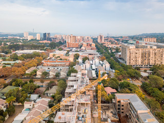 Developing Pretoria with crane on construction site, South Africa