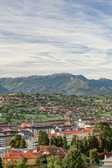 Obraz premium A beautiful European city at the foot of a mountain against a blue sky