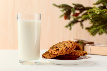 Milk and cookies for Santa Claus under the christmas tree. Concept, copy Space.