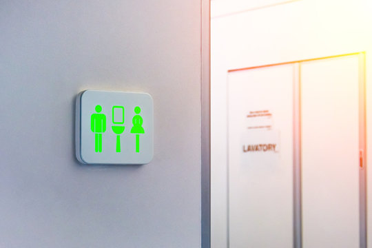 Not Occupied Toilet Sign Is Marked In Green, Against The Background Is A Door From The Wc Inside The Plane.