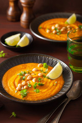 creamy carrot chickpea soup on dark rustic background