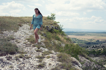 Naklejka na ściany i meble Young attractive girl is resting in the mountains.