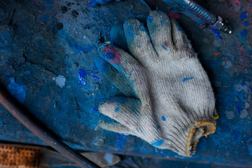 Old and dirty working gloves ,Dirty glove on cement ,dirty hand glove made by cotton ,automotive tool 
