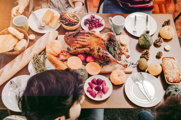 Roasted  chicken or turkey with sauce and grilled autumn vegetables: corn,pumpkin  on wooden table, top view, frame. Christmas or Thanksgiving Day food concept.