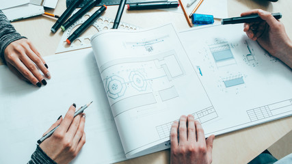 Interior design. Architect teamwork. Creative engineers working on project with scheme.