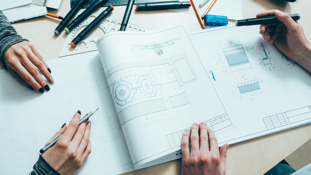 Interior design. Architect teamwork. Creative engineers working on project with scheme.