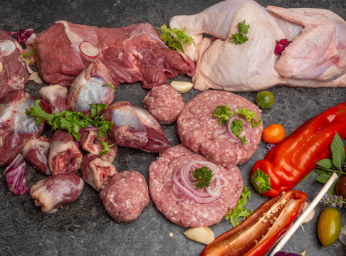 Different Types Of Raw Meat: Beef, Chicken, Lamb, Gilbert, Pork, Herbs, Lettuce, Garlic, Cherry Tomatoes, Bell Pepper, Greenery