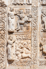 Scenes of biblical stories engraved on marble wall in Italy