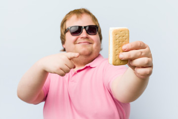 Caucasian crazy blond fat man holding an ice cream