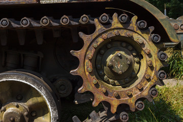 Wheels and tracks of the tank. Military equipment background. Close-up