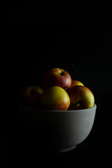 apples in a ceramic bowl.