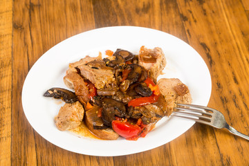 Platter of Pork Tenderloin Medallions in Mushroom and Tomato Sauce with Onion and Spices