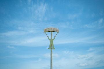 Military training target - paratrooper. Green wooden man infront of a blue sky. Summertime. 