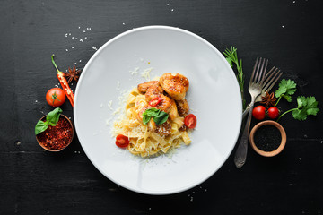 Pasta with Chicken and Parmesan. On a wooden background. Top view. Free space for your text.