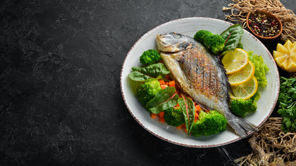 Dorado fish with grilled vegetables. Seafood. Top view. Free copy space.