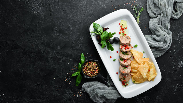 Goose liver pate on a plate. Fuagra. Restaurant dishes. Top view. Free space for your text.