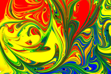 Multicolored abstract background pattern created with red, yellow, blue and green liquid paint swirls