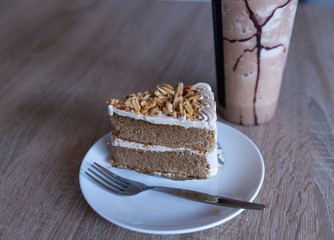 Almond Coffee Cake with vanilla latte on wood table 