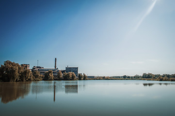 Fototapeta premium Landscape of a factory by the lake