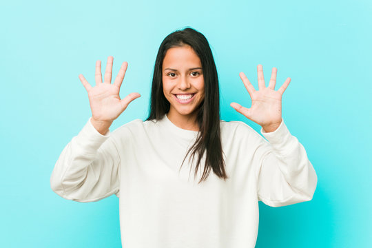 Young pretty hispanic woman showing number ten with hands.