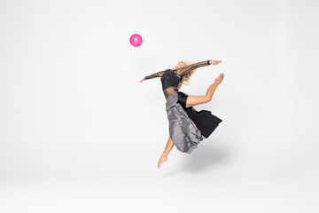 Gymnastics Professional athlete performs with ball isolated on white background