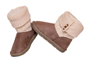 Winter boots. Close-up of a pair elegant brown suede leather winter boots with wool and lined with fur. Girls winter shoe fashion new collection. Isolated on a white background. Macro.
