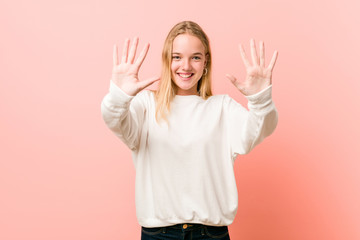 Young blonde teenager woman showing number ten with hands.