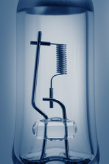 Car lamp close-up on a blue background. Tungsten spiral car headlights on a blue background.