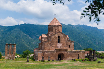 Fototapeta na wymiar Odzun Church (5th-7th century) surrounded beautiful trees and mountains, Armenia