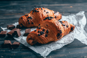 delicious sweet chocolate croissants dark wooden table